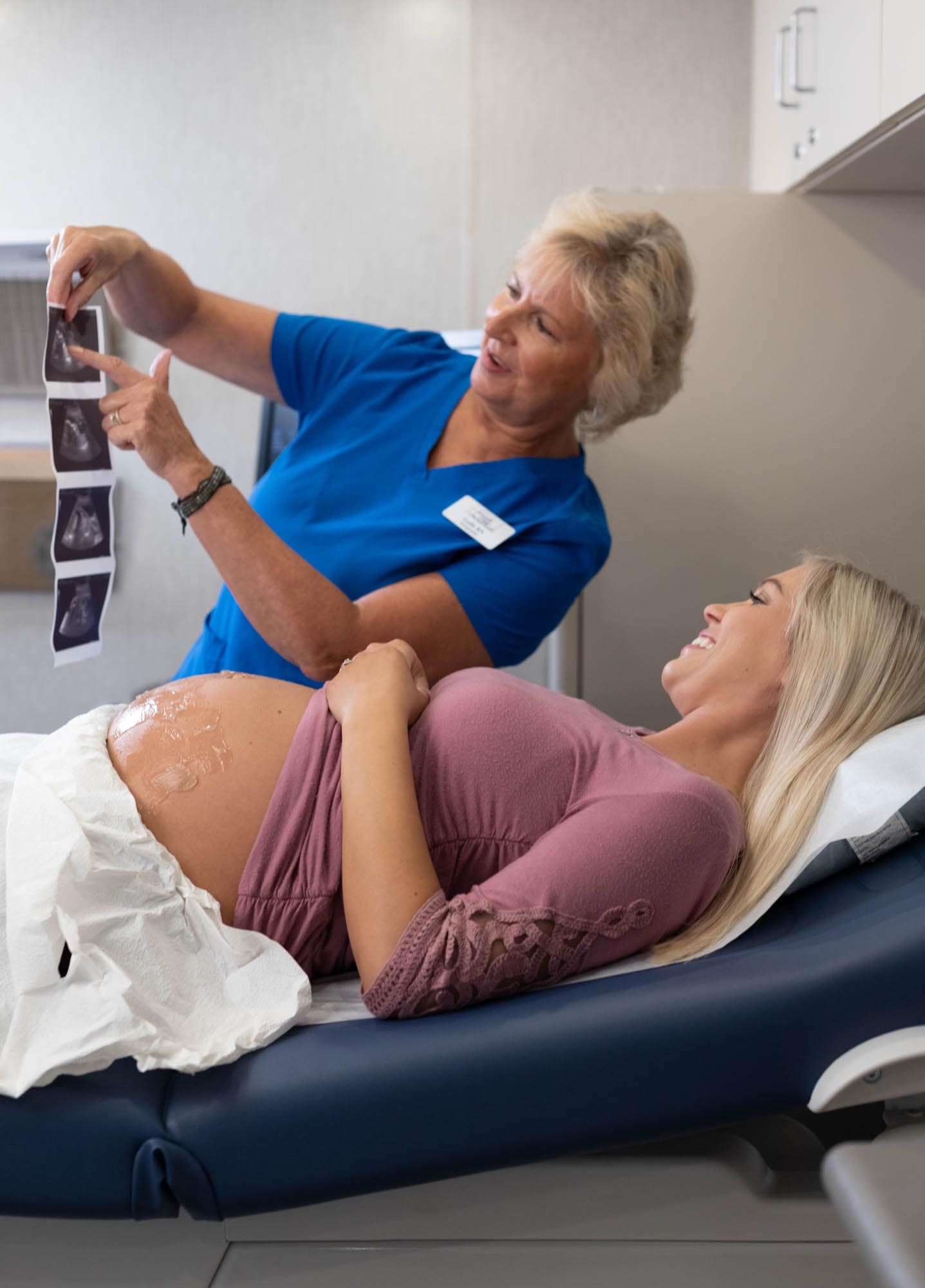 icumobile_35085 A woman looking at her ultrasound pictures provided by ICU Mobile